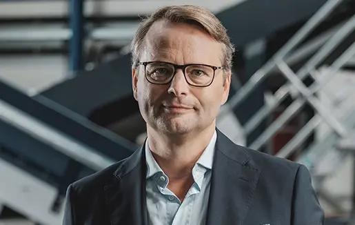 Stefan Chalupnik, Managing Director at G. CORETH Kunststoffverarbeitungs GmbH, looks into the camera with a slight smile on his face.