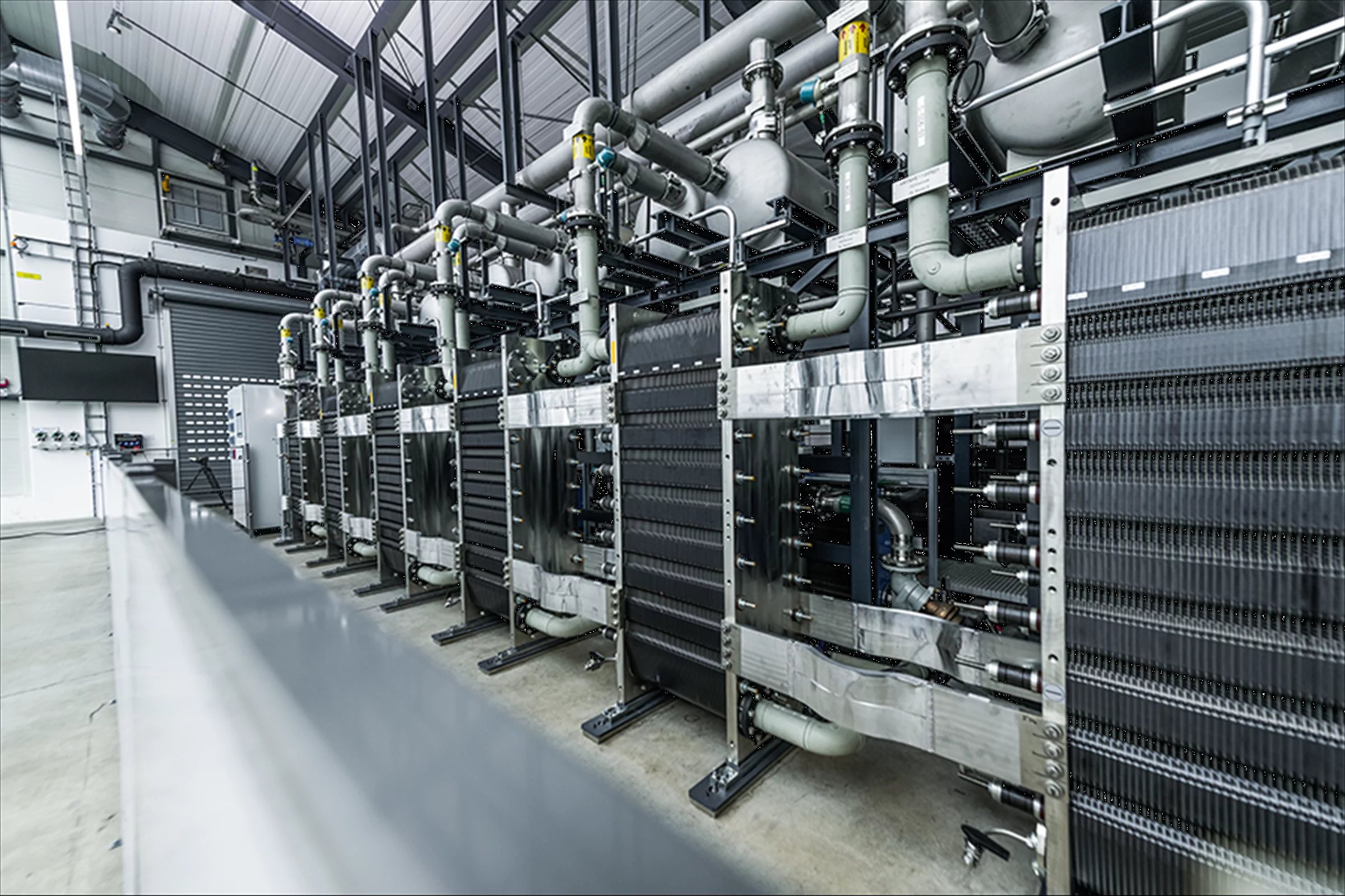 A view into a hydrogen project, showing a complex system of pipes and machinery.